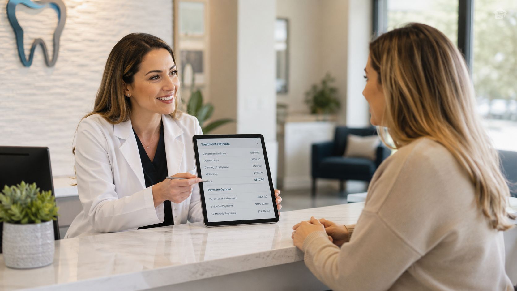 A friendly dentist presenting a treatment estimate and payment plan options to a patient on a tablet.